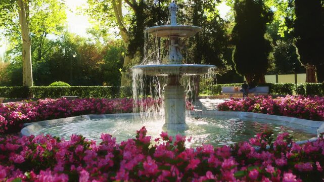 Park Retiro, beautiful fountain with blooming flowers in El Retiro Park, Madrid, sightseeing in Madrid, capital of Spain.