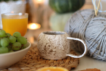Pumpkins, various food and drinks, fall decorations, books and candles on the table. Fall hygge at home. Selective focus.