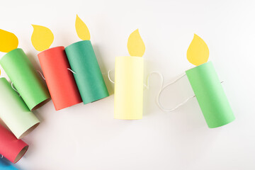Colorful paper candle garland. Step in creative process. Festive and party decoration concept for...