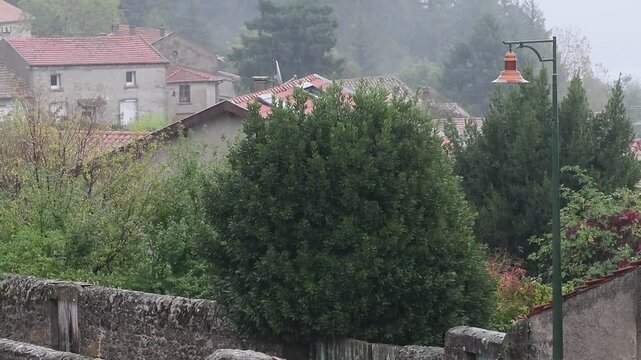 Rainy weather in a mountain village in France in the Auvergne Rhone Alpes region. Rain in autumn.