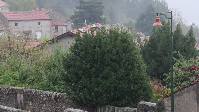 Rainy weather in a mountain village in France in the Auvergne Rhone Alpes region. Rain in autumn.