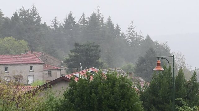 Rainy weather in a mountain village in France in the Auvergne Rhone Alpes region. Rain in autumn.
