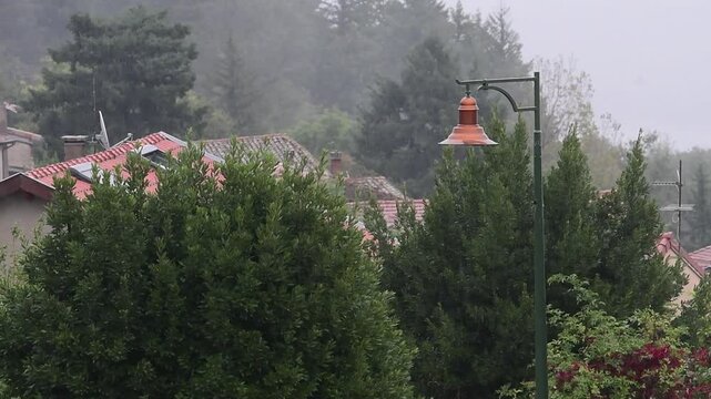 Rainy weather in a mountain village in France in the Auvergne Rhone Alpes region. Rain in autumn.