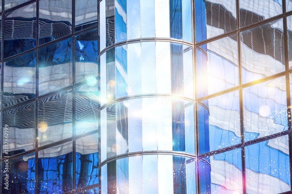 Poster reflective glass panels of a building in hong kong create a kaleidoscope of blue, white, and light.