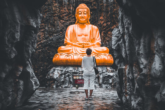 Samut Sakhon, Thailand - September, 25, 2024 : Meditation in Front of a Golden Buddha in Lak Si Temple at Samut Sakhon, Thailand.