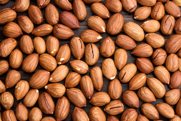 Almonds and nuts on wooden. food healthy natural concept. a tin of almonds and peeled nuts lie on a wooden . a group of peeled almonds lying on a lifestyle wooden.
