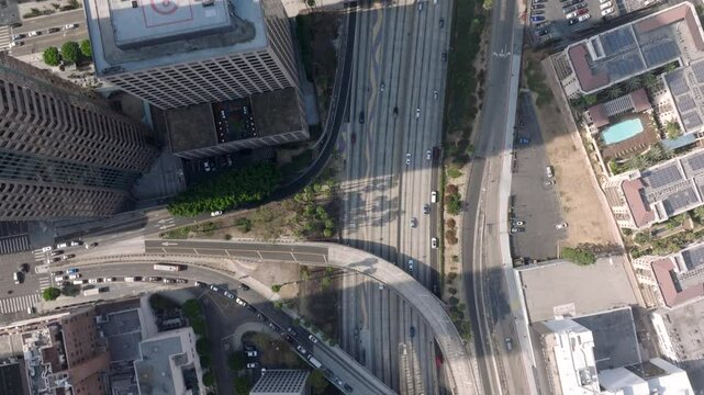Breathtaking drone shot captures the vibrant essence of Downtown Los Angeles Famous Freeway interchange, complex highways and the intricate urban landscape beautifully illuminated of sunrise