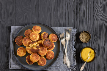Northern Pike fish cakes on dark grey plate
