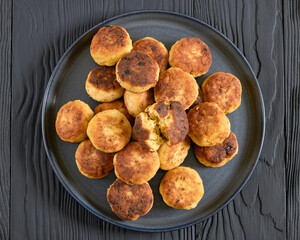 Northern Pike fish cakes on dark grey plate