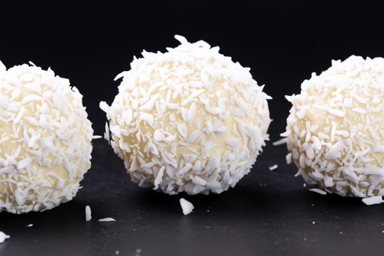 White and with candies. candy food sweet concept. a round round candies on a with raffaello. a round raffaello on a lifestyle with white candies.