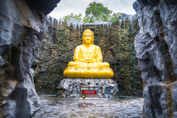 Samut Sakhon, Thailand - September, 25, 2024 : Golden Buddha Statue in Serene Cave in Lak Si Temple...