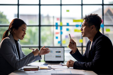 Two people are talking in a meeting room