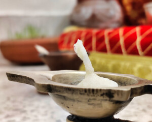Picture of candle diya in a clay pot on a marble top, Closeup shot with selective focus
