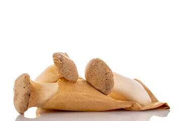 Fresh fragrant king mushrooms with paper bag, macro, isolated on white background.
