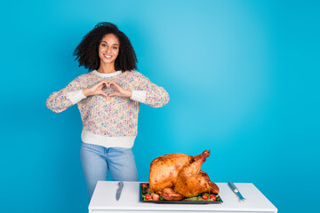 Photo portrait of pretty young girl show heart symbol thanksgiving dinner turkey isolated on blue...