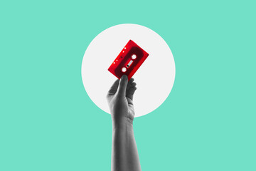 A hand holding audio cassette. Vintage red music cassette poster. Contemporary flat design art...