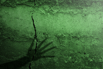 Shade of witch hands on dark background. The hand appearing to be devil, evil, satan, or monster hands