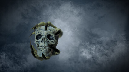 Witch hand with long black nail holding human head skull through smoke, gives the image a spooky and scary mood