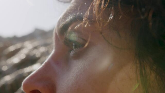 Woman's eyes looking at the sea at sunset in summer, Marseille, France