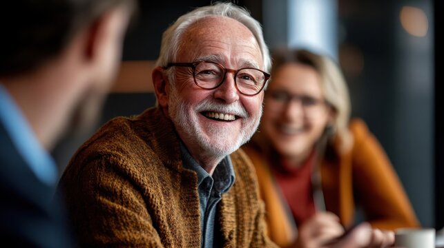 Happy elderly man enjoying a conversation with friends in a cozy cafe, smiling and engaged in lively discussion. - Powered by Adobe