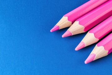 Vibrant pink pencils on blue background