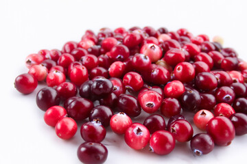 Lingonberry with white berries on a. Cranberry cowberry berry concept. Lingonberries in red on white. Lingonberries in red and white lifestyle on a.