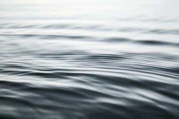 Gentle waves create a fluid pattern on the water's surface, capturing a moment of natural rhythm and gentle movement.