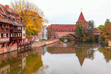 Kettensteg pedestrian chain bridge over river in Nuremberg, Bavaria Germany. Scenic river flows...