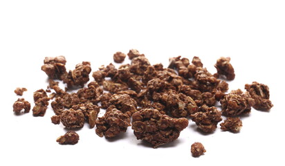 Crunchy granola, muesli pile with chocolate isolated on white background, side view