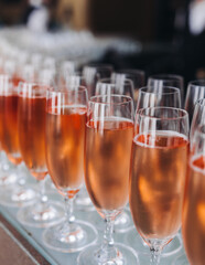 Alcohol setting on catering banquet table, bartender pouring liquor beverages, row line of different colored alcohol drinks on a party, glass of wine, sparkling wine on decorated banquet table event