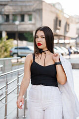 Fototapeta premium Elegant Urban Fashionista Showcasing Modern Style in a Bustling City Environment
