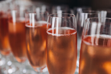 Alcohol setting on catering banquet table, bartender pouring liquor beverages, row line of different colored alcohol drinks on a party, glass of wine, sparkling wine on decorated banquet table event