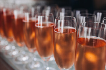 Alcohol setting on catering banquet table, bartender pouring liquor beverages, row line of different colored alcohol drinks on a party, glass of wine, sparkling wine on decorated banquet table event