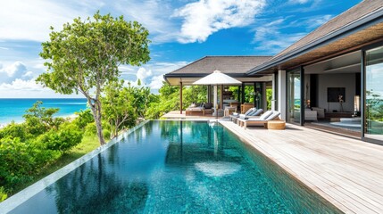 Fototapeta premium Stunning villa by the beach with a crystal-clear pool, no people. Open space for copy on the deck