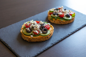 Mediterranean Hummus Toast with Cucumber, Tomato, Olive, and Feta - Close-Up