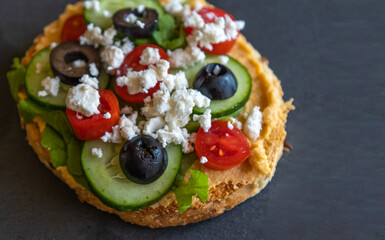 Mediterranean Hummus Toast with Cucumber, Tomato, Olive, and Feta - Close-Up