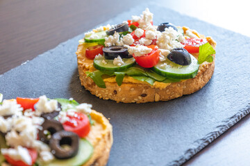 Mediterranean Hummus Toast with Cucumber, Tomato, Olive, and Feta - Close-Up