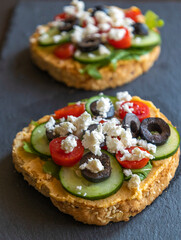 Mediterranean Hummus Toast with Cucumber, Tomato, Olive, and Feta - Close-Up