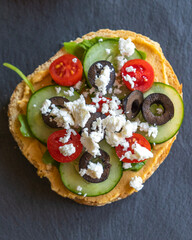 Mediterranean Hummus Toast with Cucumber, Tomato, Olive, and Feta - Close-Up