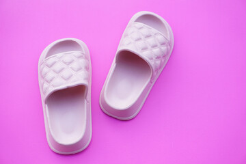 Pairs of pink rubber slippers, shoes for easy day wearing and walking, isolated on pink background. concept, fashion shoes , light and comfortable.    