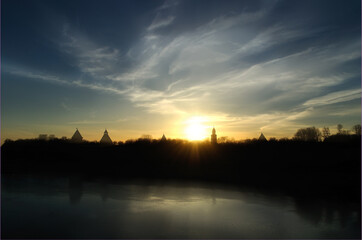 Fototapeta premium Veliky Novgorod Russia. Silhouette architectural landscape - towers of Veliky Novgorod Kremlin, Russia, at the sunset under the rays of sunlight