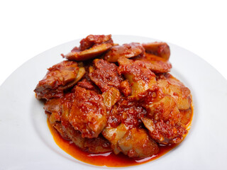 Jengkol Balado or dogfruit with red chili sauce, a spicy traditional Indonesian dish from West Sumatra, served on a white plate with a clean white background