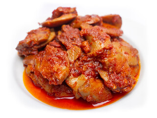 Jengkol Balado or dogfruit with red chili sauce, a spicy traditional Indonesian dish from West Sumatra, served on a white plate with a clean white background
