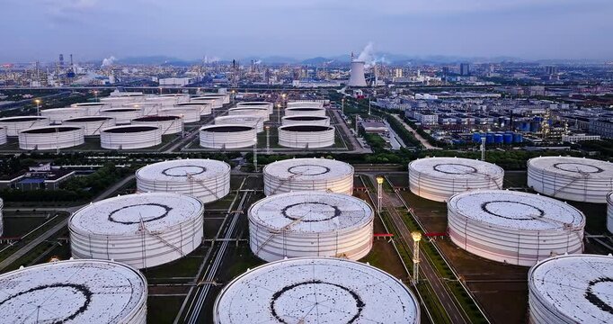 Aerial view of large white industrial oil tanks scenery at night. Business fuel and energy.