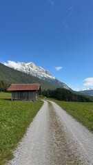 country road in the mountains with a small house countryside