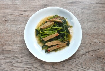 fried Chinese kale with slice gluten vegetarian food on plate 