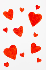 Patterns of red hearts painted with acrylic paints on a white background. Pattern for Valentine's Day. Suitable for backgrounds, wrapping paper, post cards.