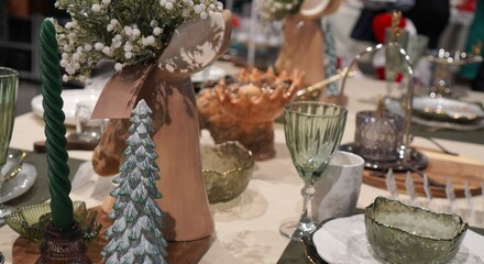 tableware for festive winter table setting for new year and christmas on linen natural tablecloth close-up