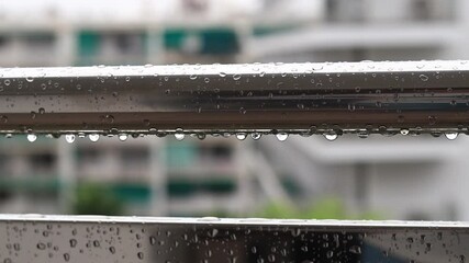 Balcony railings in the rain, selective focus. Close-up of balcony railing with raindrops, wet balcony. Raindrops falling on balcony railings. Water drops - Powered by Adobe