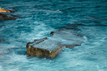 Fototapeta premium Long exposure of a rock in the sea next to EDRO III in Paphos, Cyprus (Mediterranean sea).